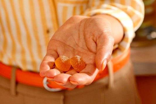 Hand holding 2 OLLY Probiotic Gummies