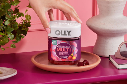Woman reaching for OLLY Women's 40+ Multi