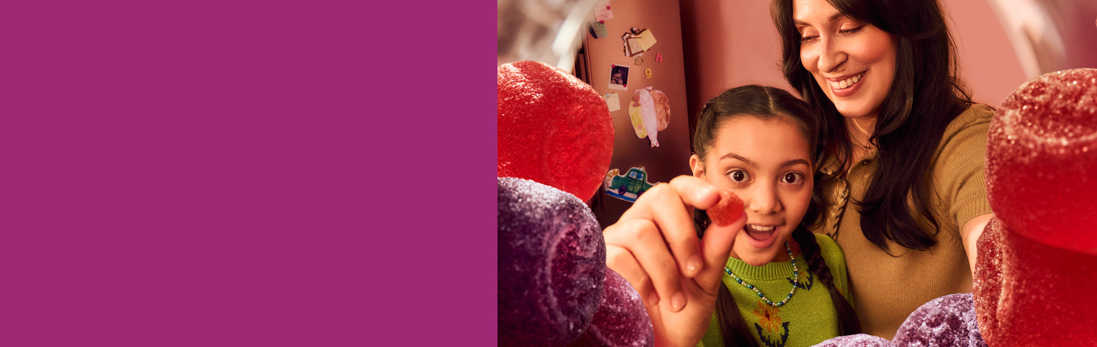 Woman with child holding an OLLY gummy