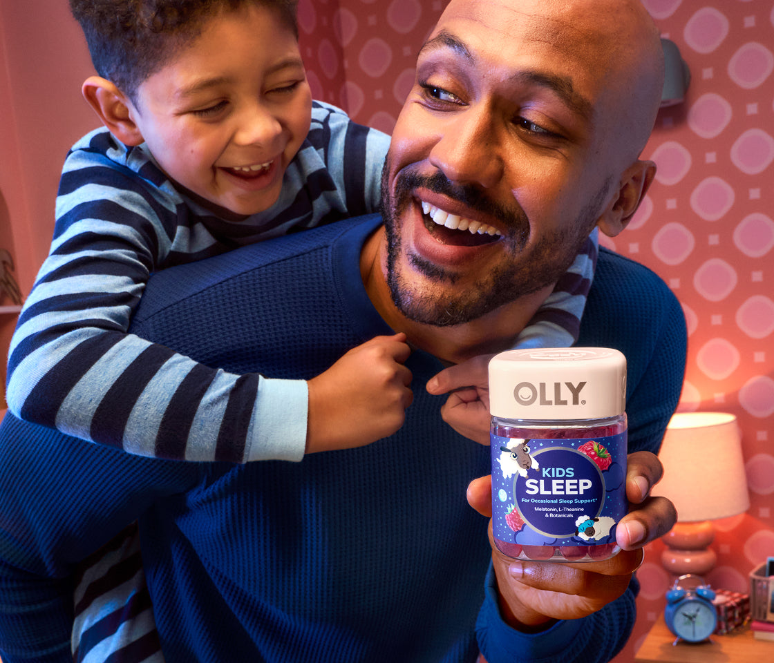 Man holding Kids Sleep with child hugging his back.