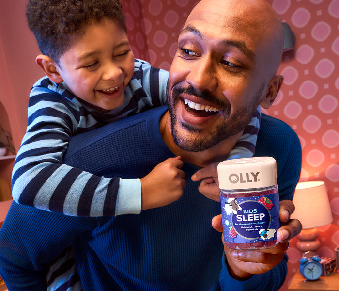 Man holding Kids Sleep with child hugging his back.