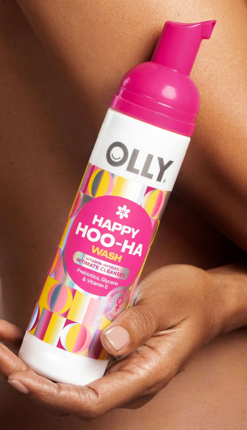Woman holding Olly Happy Hoo-Ha Wash icon